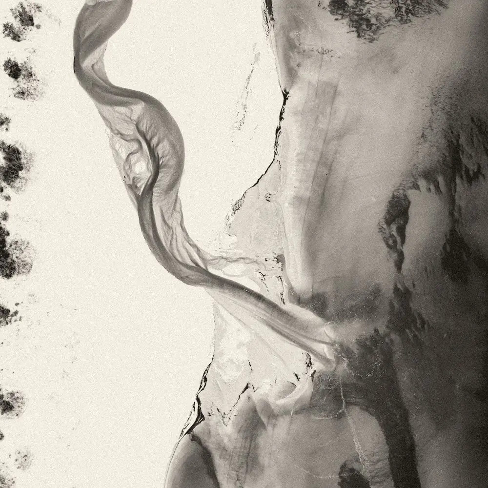 Aerial photo of two rivers of different colours meeting and flowing on as one